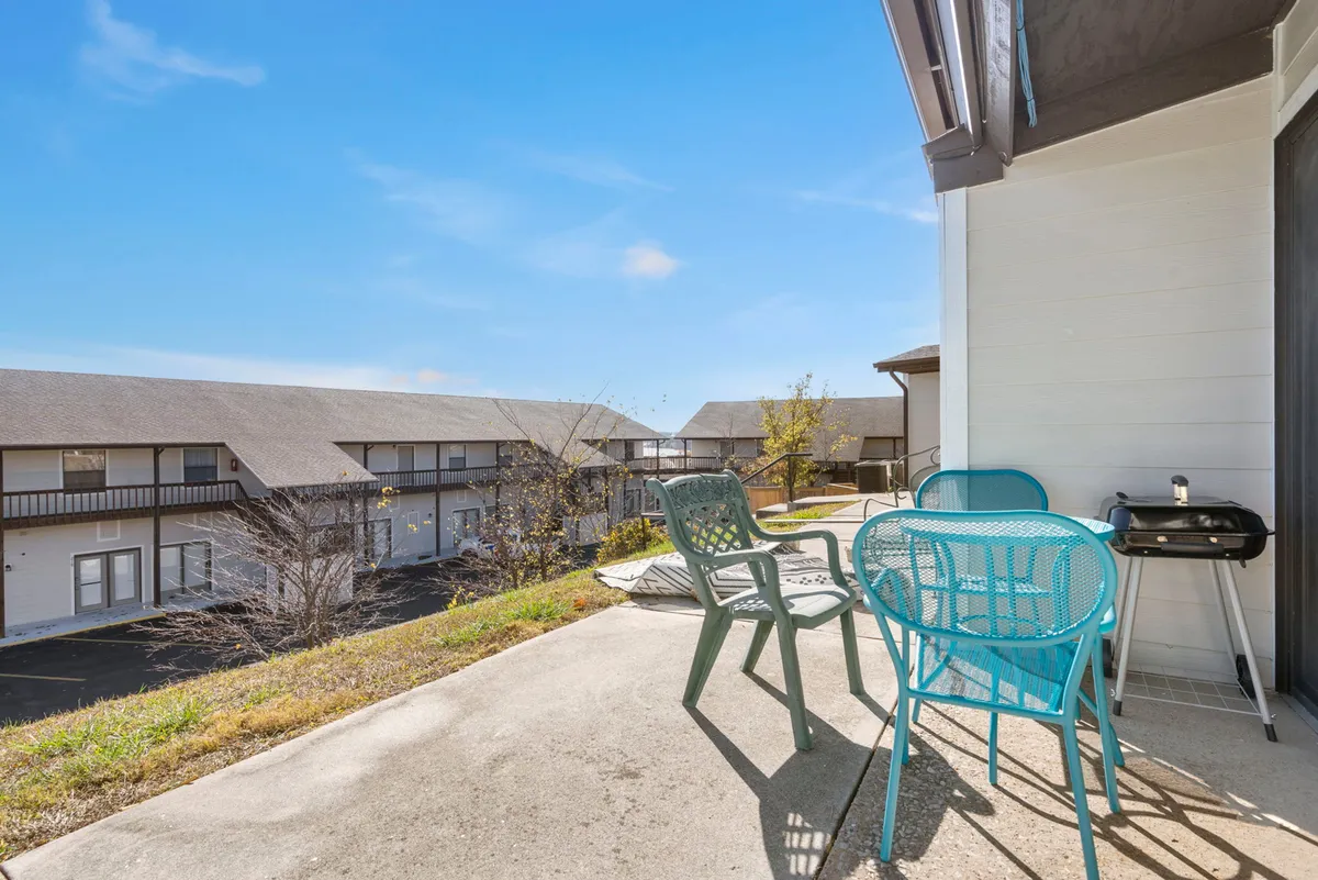 An inviting exterior patio with comfortable outdoor seating, a grill for intimate barbecues, and a panoramic landscape view. The space feels private and cozy, ideal for sipping morning coffee or sharing a quiet moment together while overlooking nature.